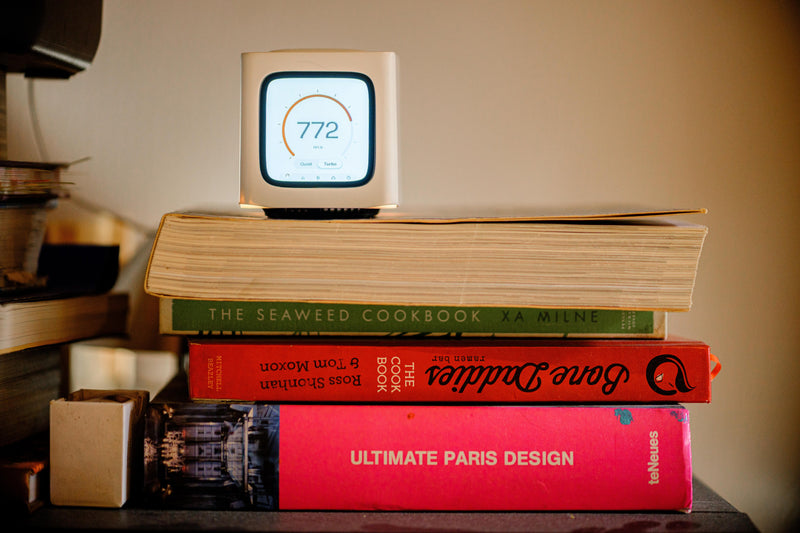 Bitcube on top of a stack of cookbooks