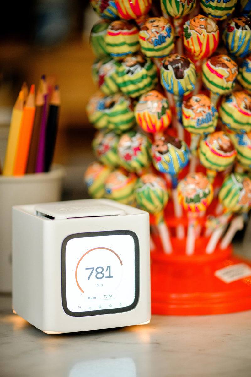 Bitcube on a counter next to a lollipop stand