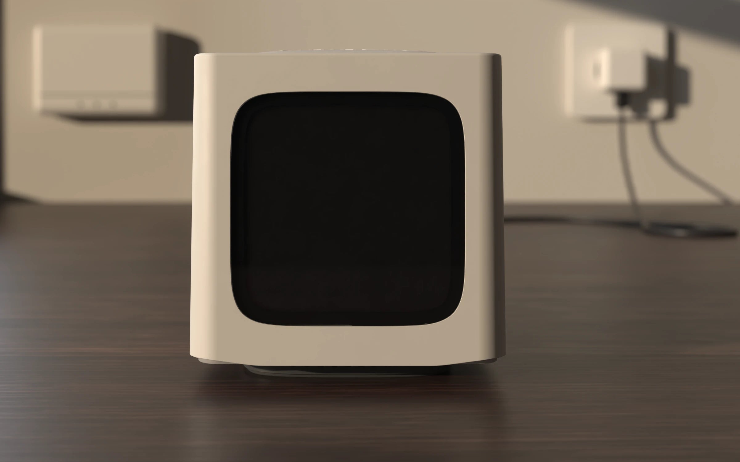 The Bitcube on a dark desk in morning light, switched off.